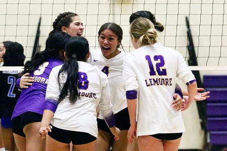 Lemoore's varsity girls' volleyball team celebrates a point in Tuesday's home match against Hanford West.